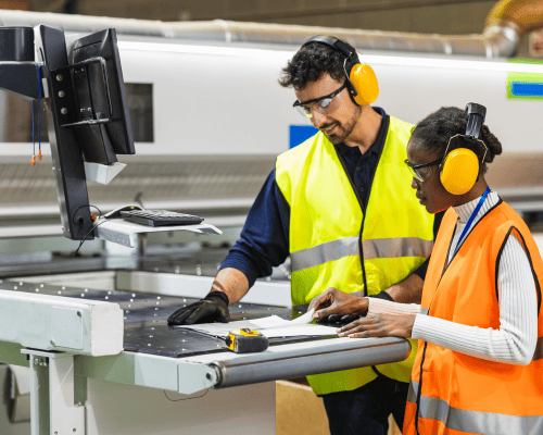 Manufacturing Team discussing production at machine with computer technology 